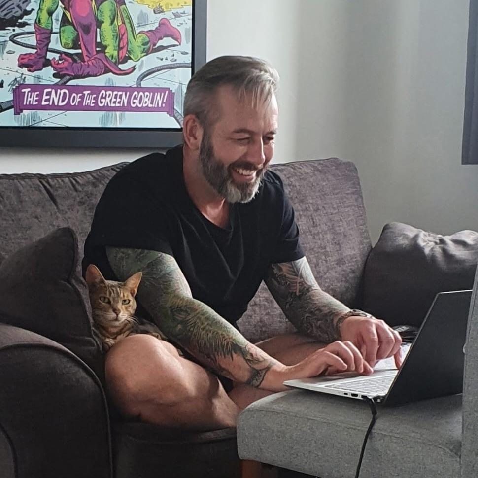 Brett N Holmes writing with his cat