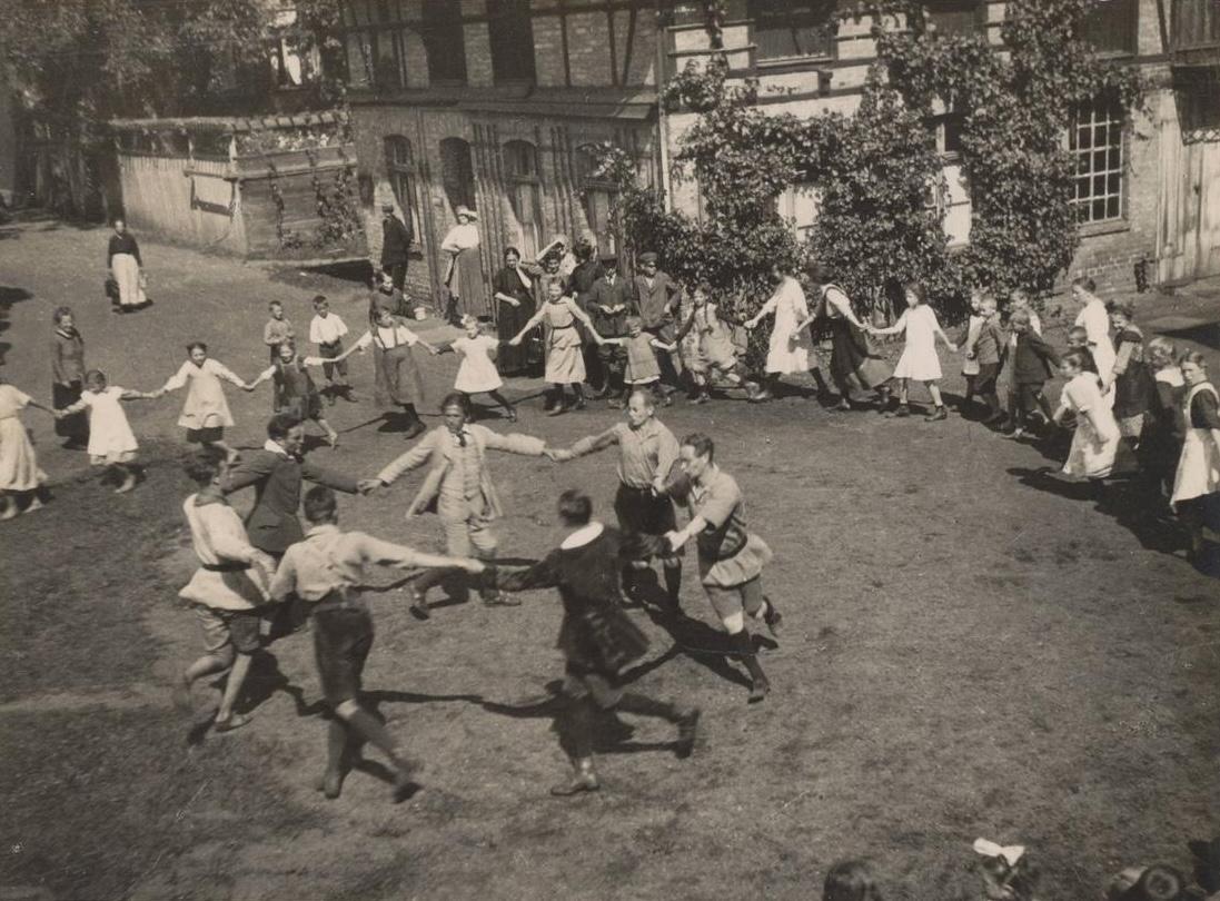 <p>A traditional round dance of the kind favoured by Muck-Lamberty (centre, wearing his ‘hiking suit.’)</p>