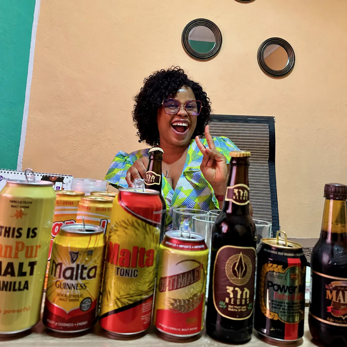 A smiling research participant seated behind a range of drinks