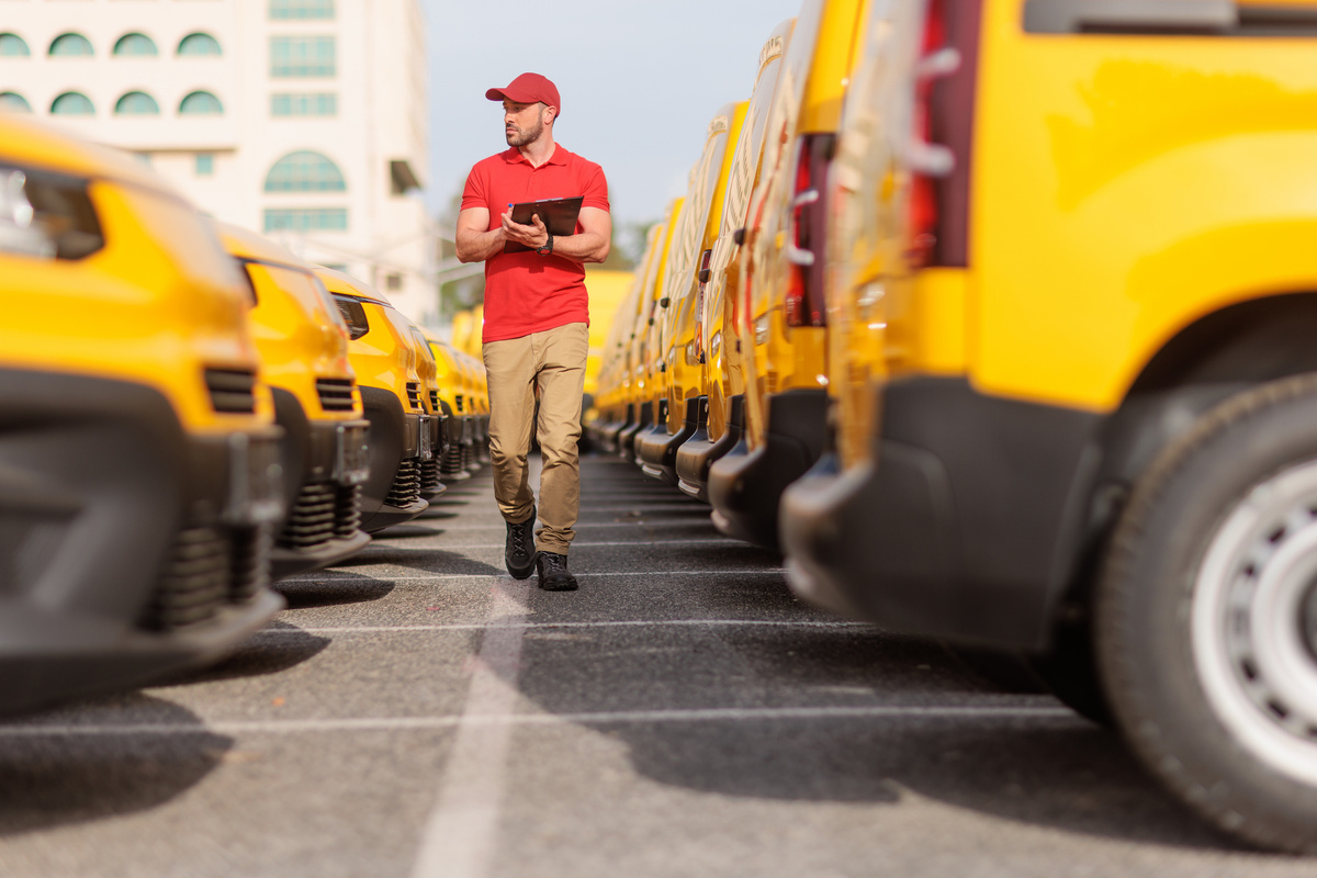 Fleet manager checking a fleet of yellow vans