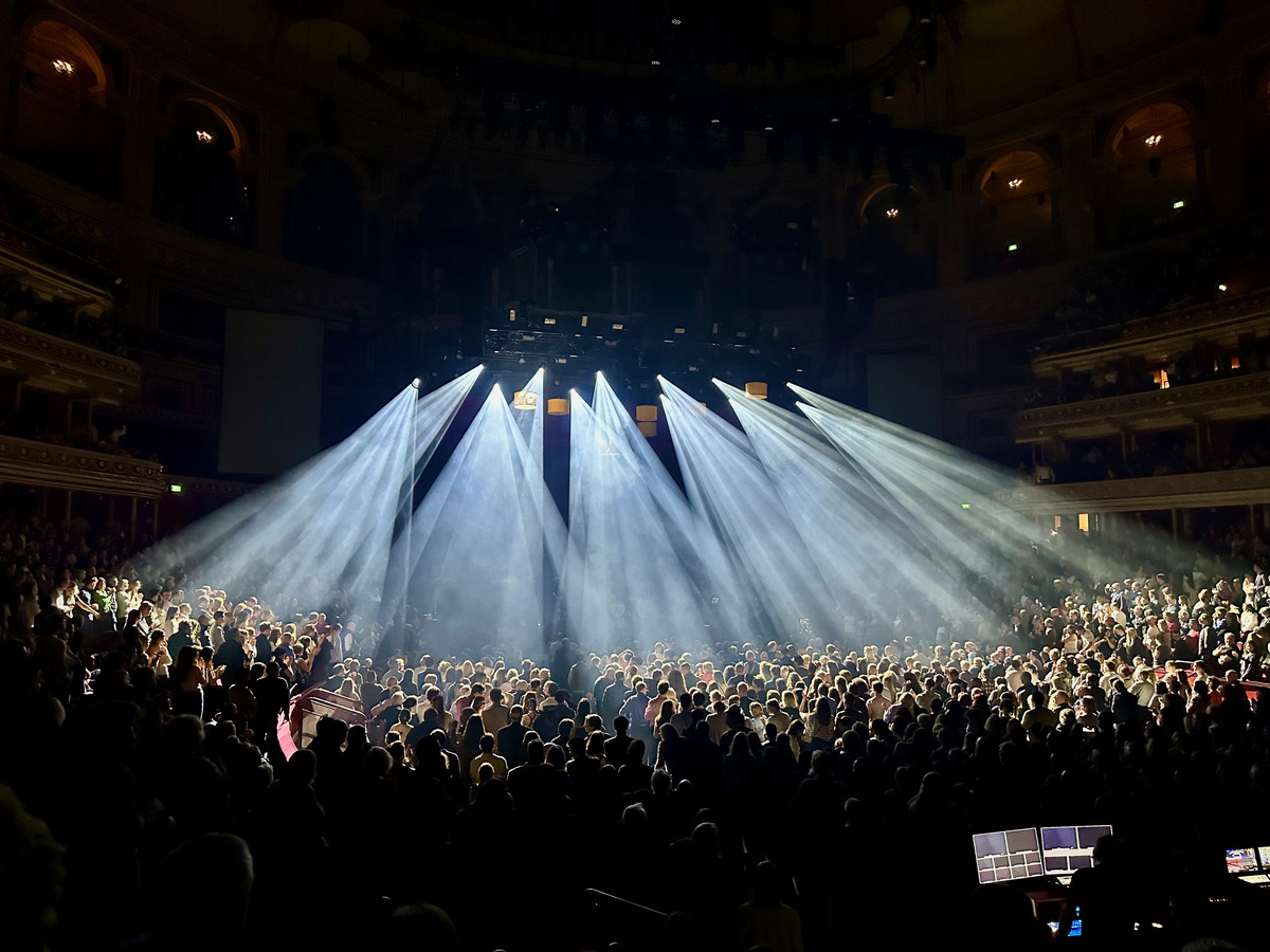 A crowd gathered beneath beams of light