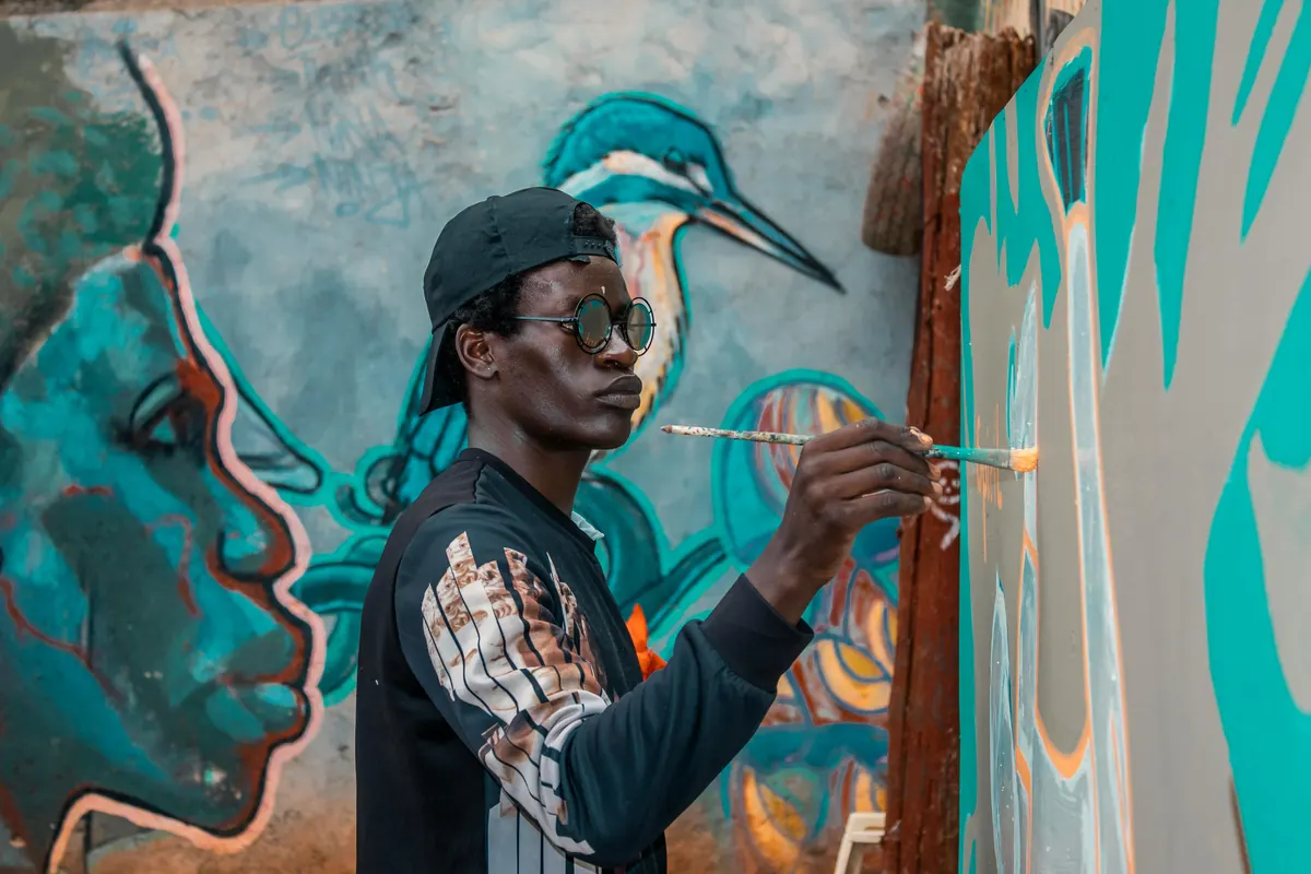 Artist painting a colourful mural