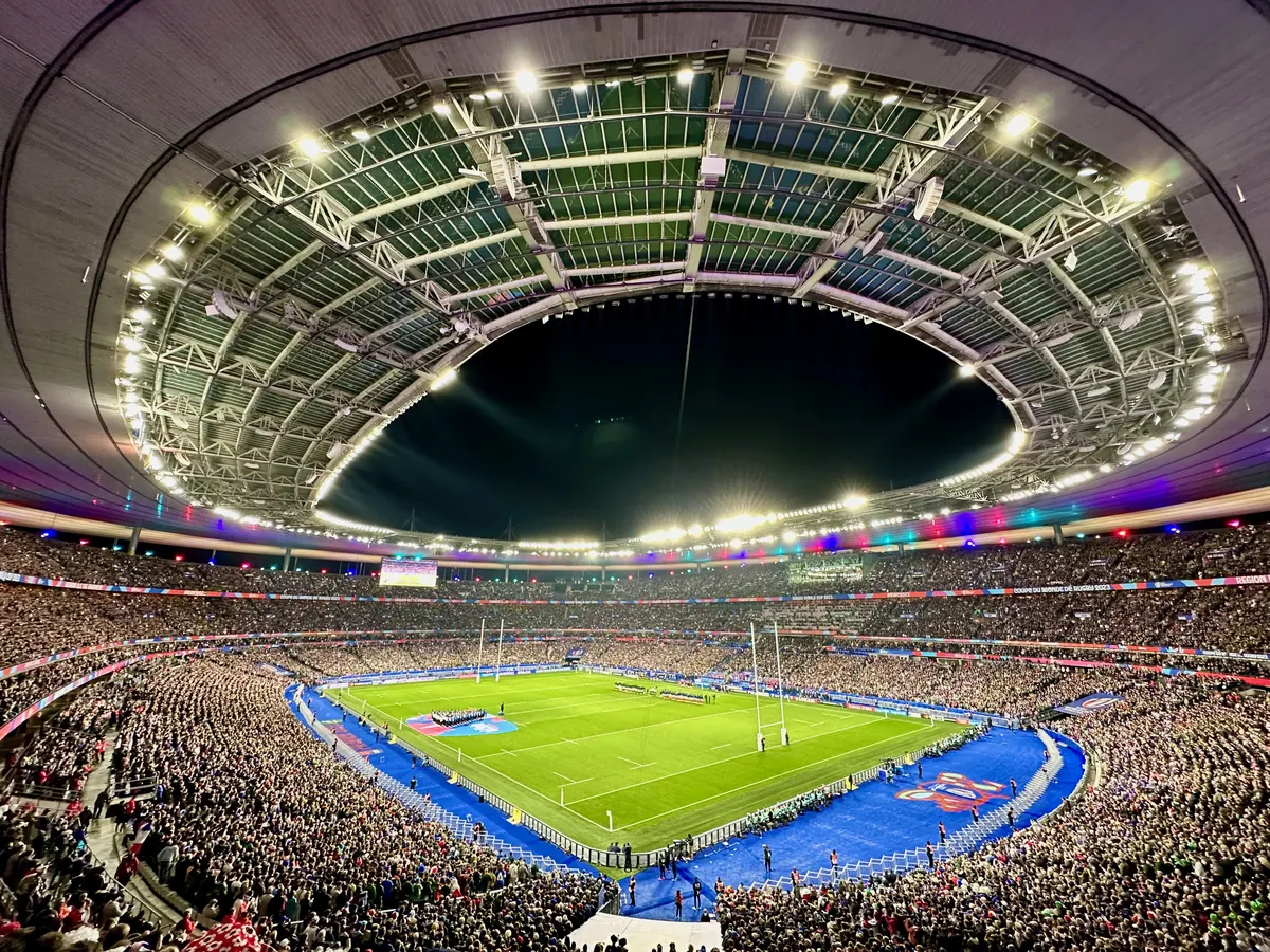 A packed stadium seen from above during an evening match