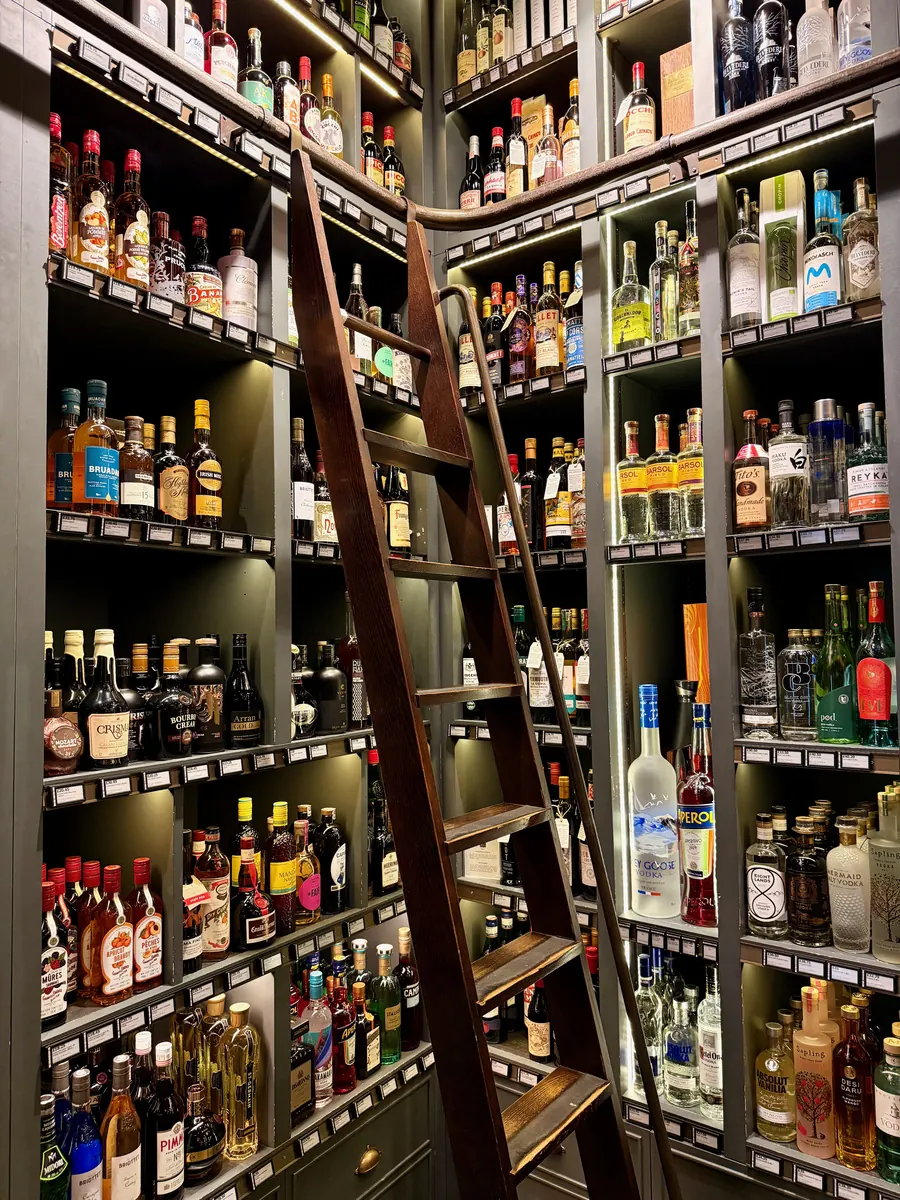 Illuminated shelves filled with whisky and other spirits