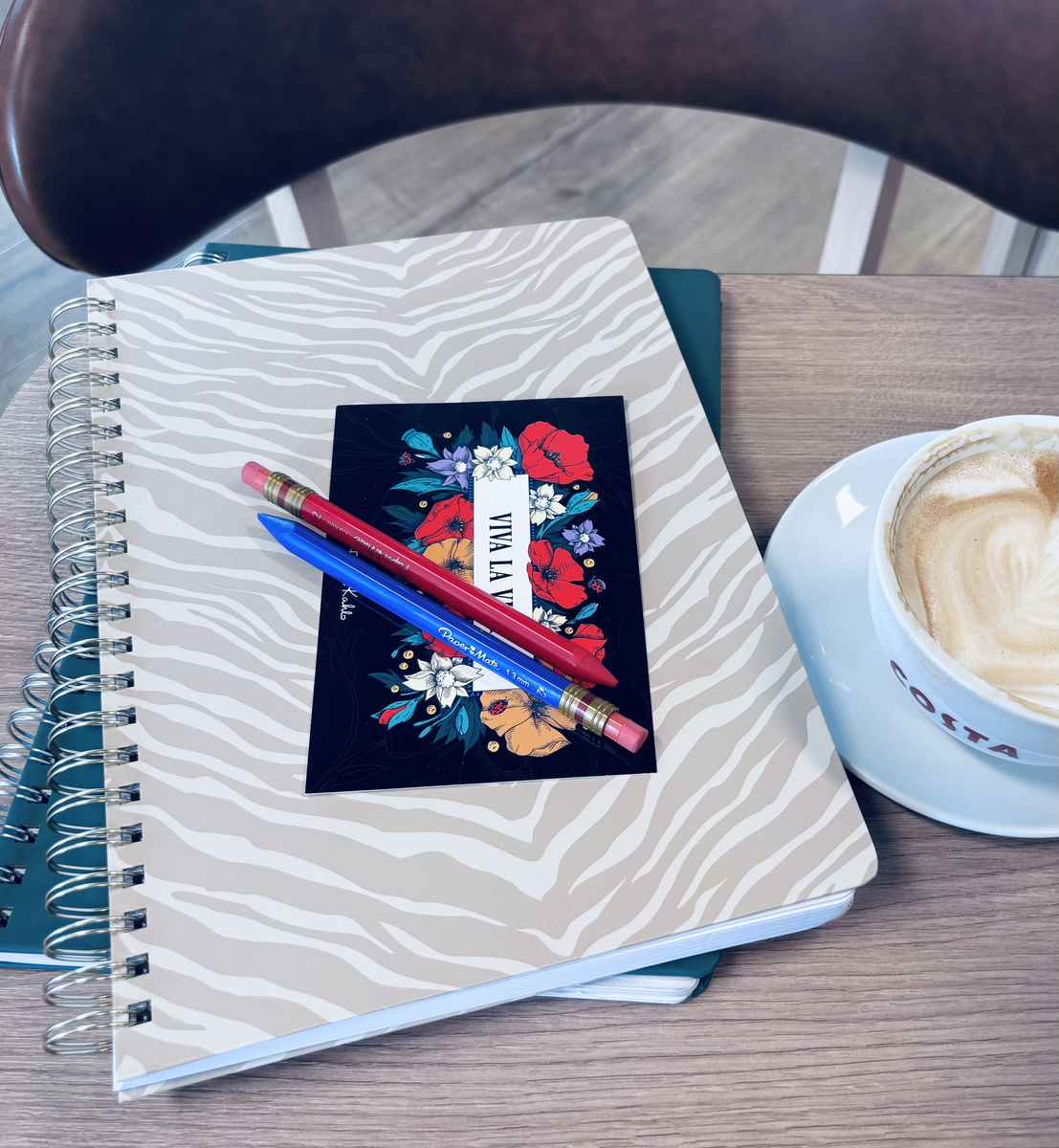 Spiral-bound notebooks, propelling pencils and coffee