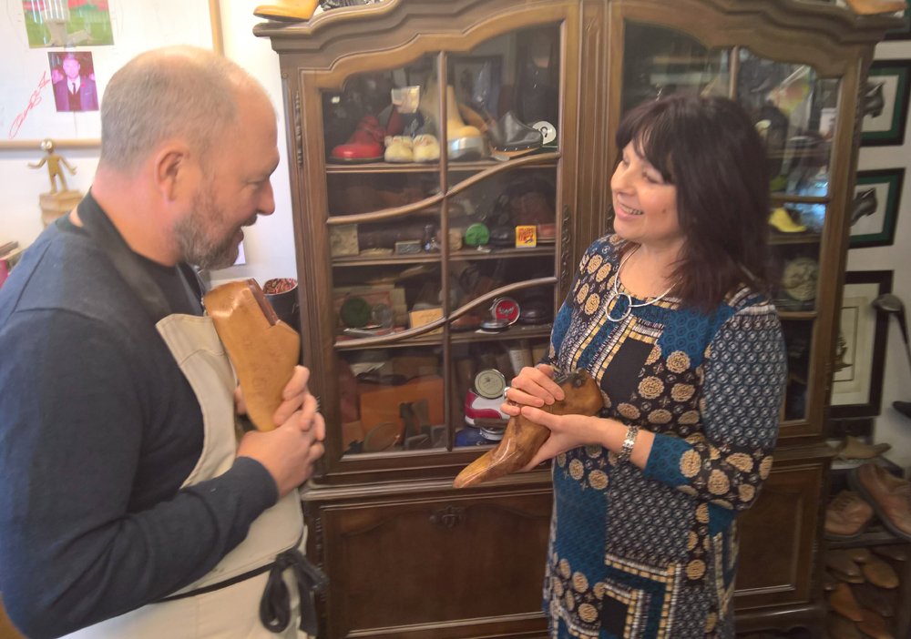 Sue Bentley and Michael James holding wooden shoe lasts at Springline