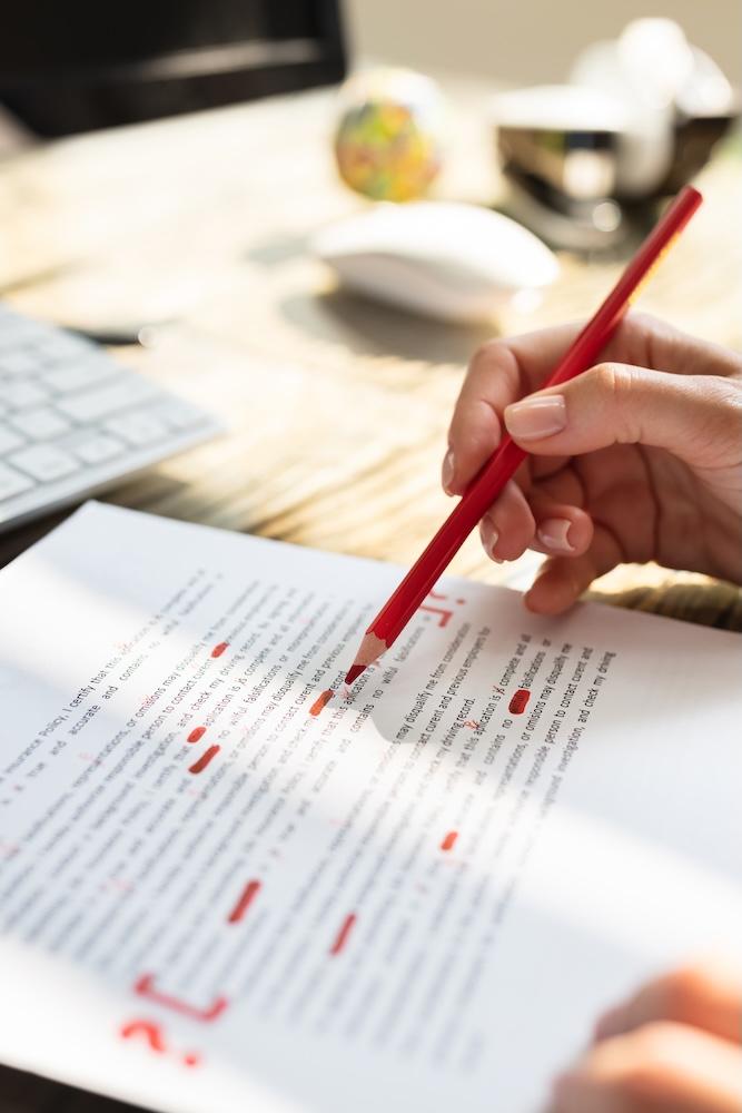 Person highlighting words on a page with a pencil