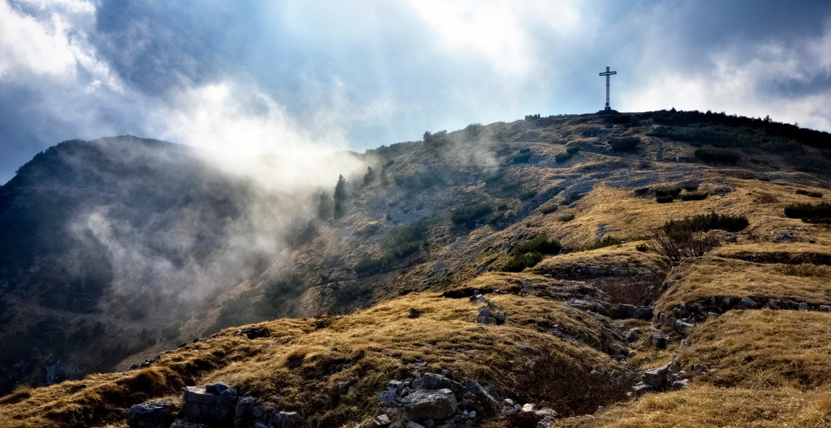 The cross on the top of Mount Maggio and the trenches of the Great War (Trentino, Italy).