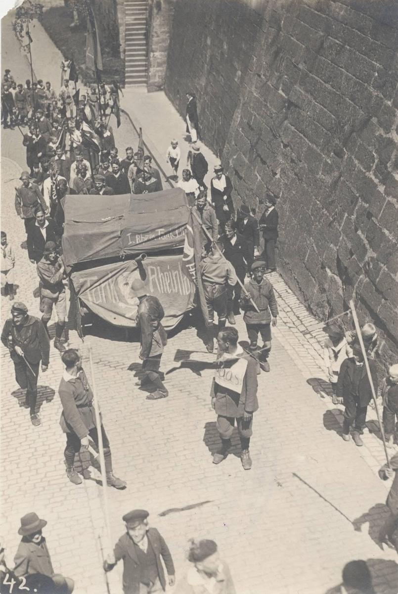 <p>Others made humorous tableaux that they paraded through the streets Here, young ex-soldiers have covered a farm wagon with a tarpaulin painted with the words Tank Rheinland and a skull and crossbones.</p>