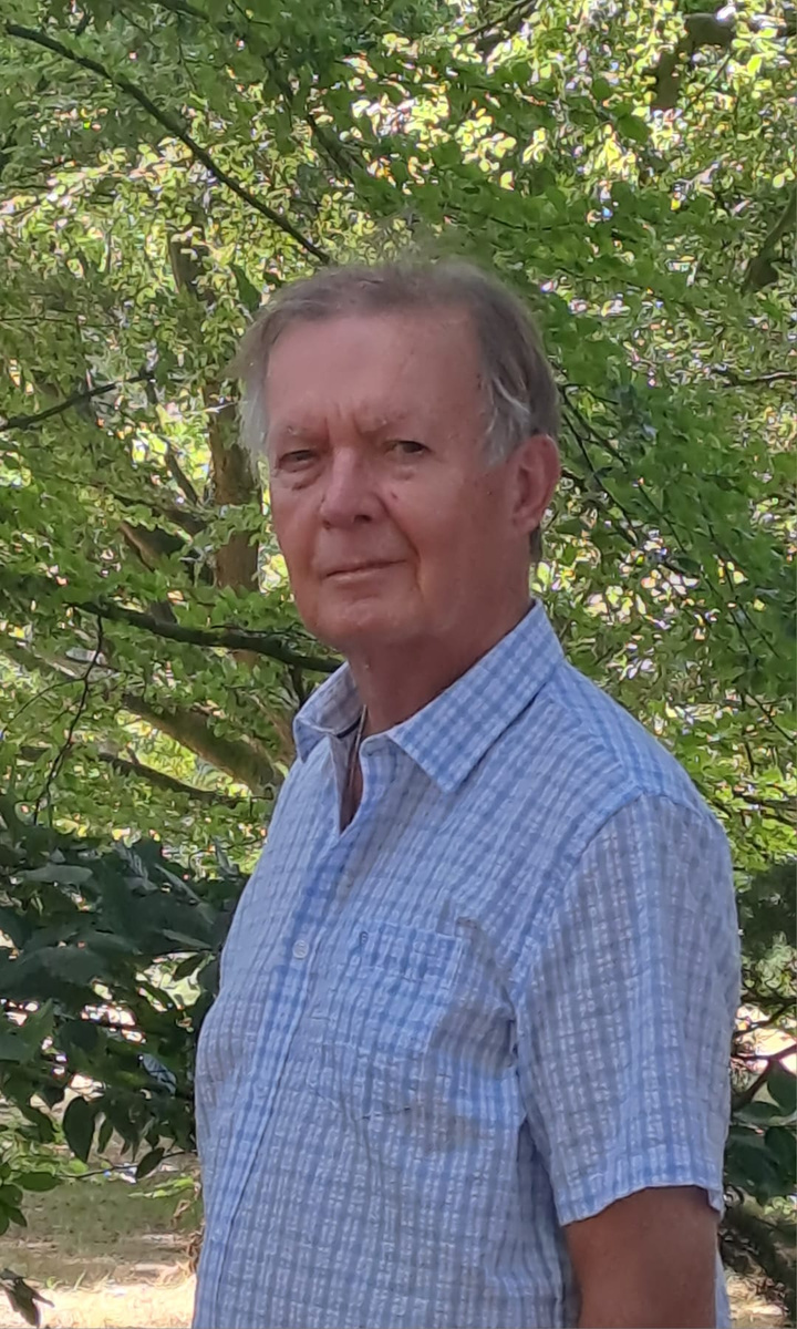 John Eaves photographed outdoors beneath a tree