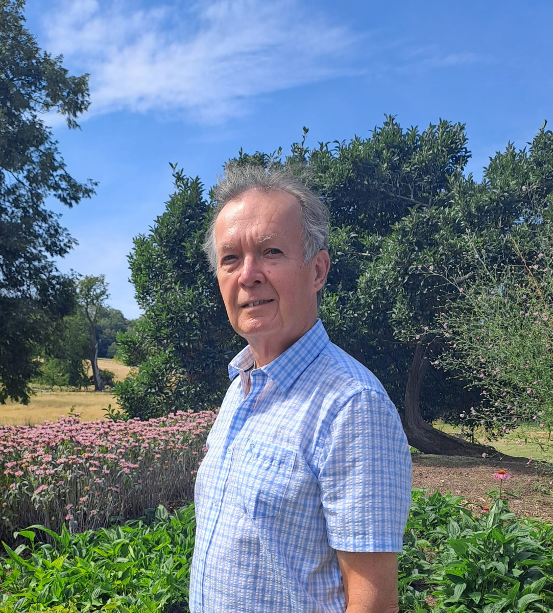 John Eaves standing in a garden on a summer day