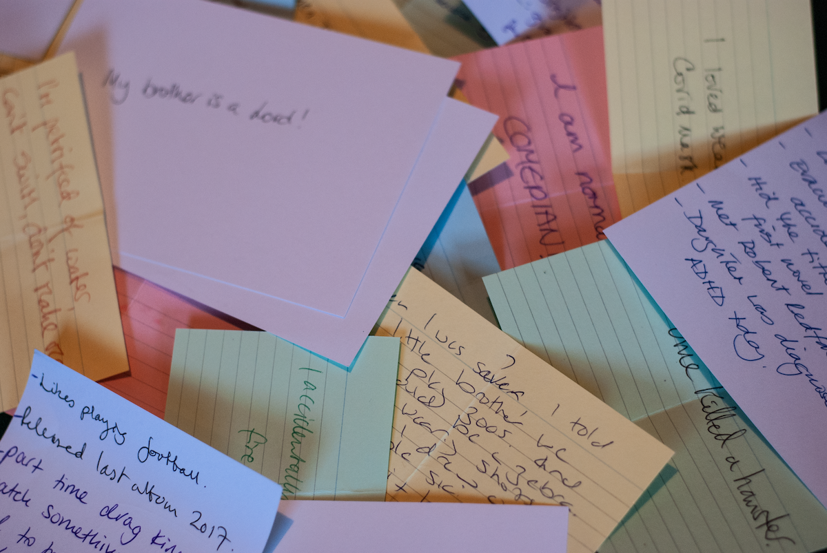 A scattered collection of handwritten notes on coloured paper, suggesting personal memories, reflections and the writing process.