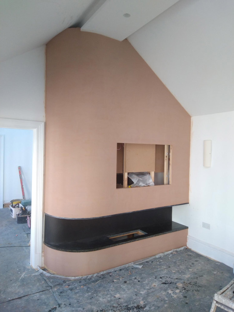 Feature chimney breast with a built-in fireplace recess in a renovated room