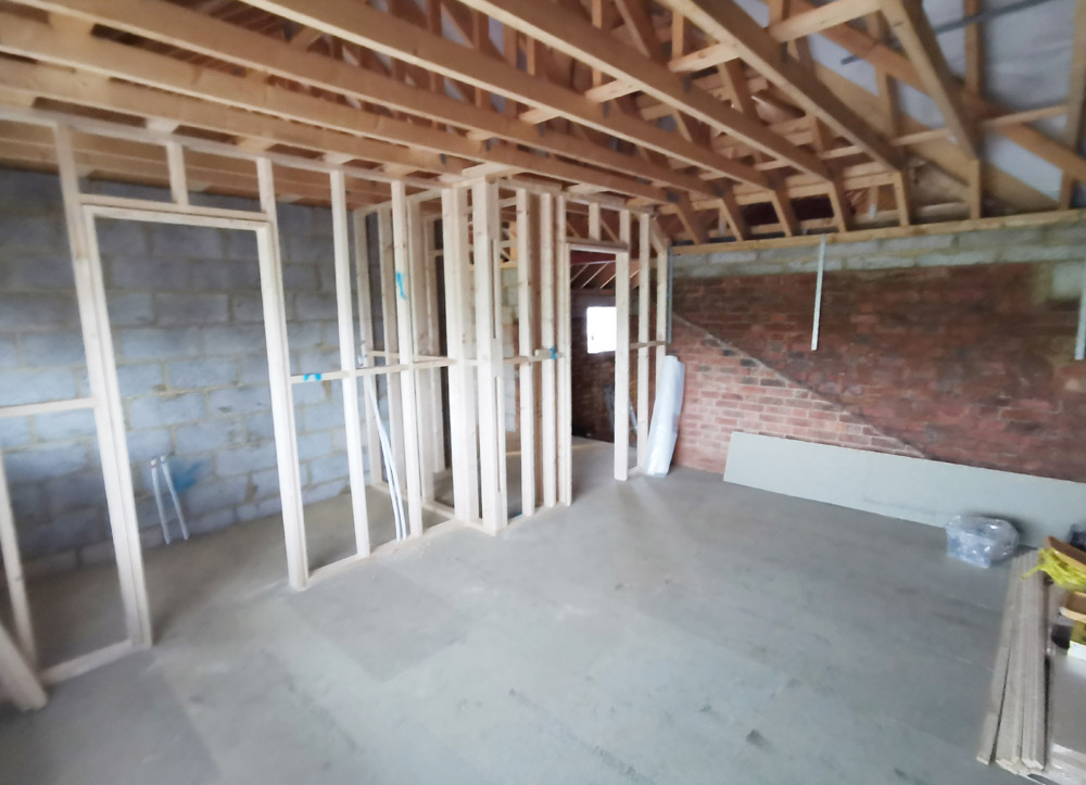 Timber stud walls framed inside a brick and block extension