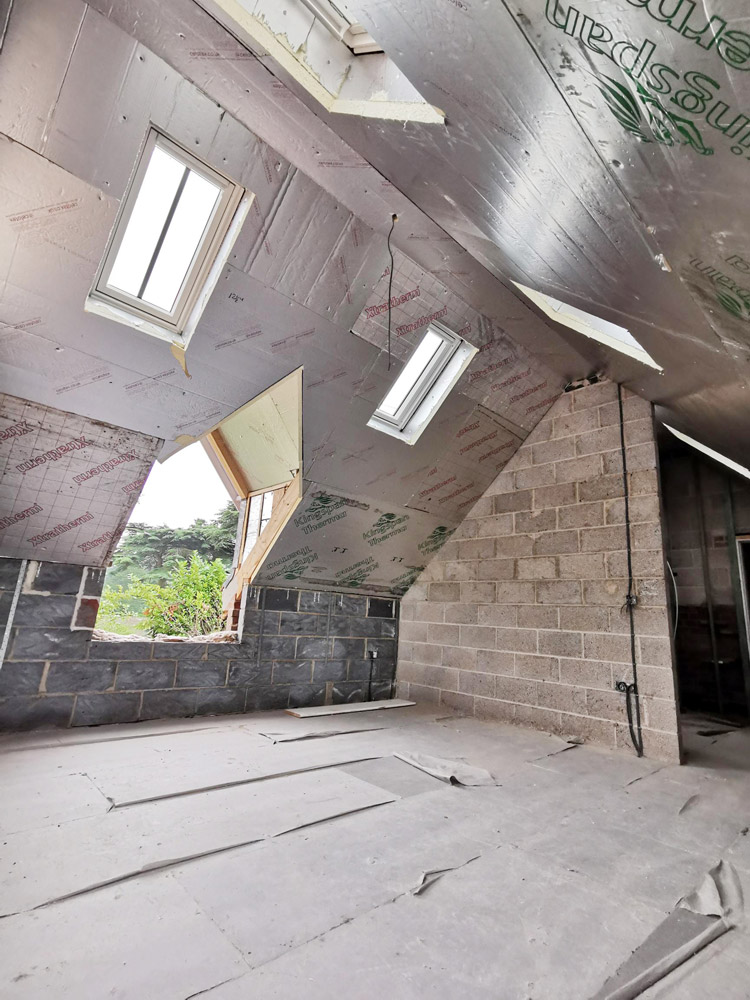 Loft conversion with roof windows, insulation and blockwork walls