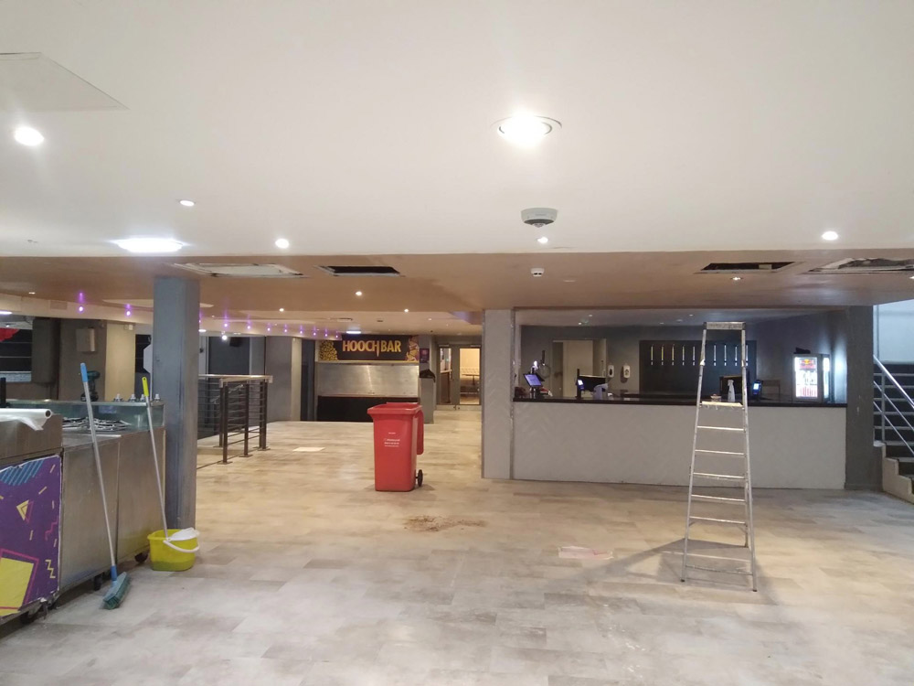 Commercial bar interior under refurbishment with a stepladder and new lighting