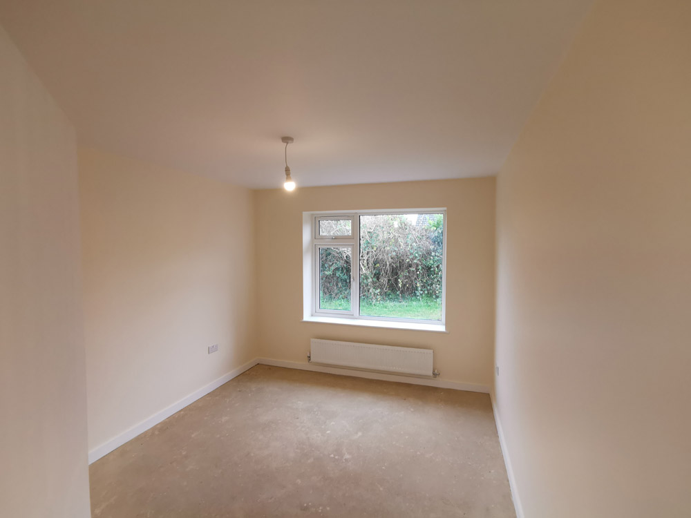 Freshly plastered room with a new window and radiator