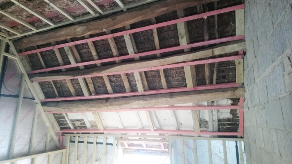 Roof structure strengthened with new timbers alongside the original rafters