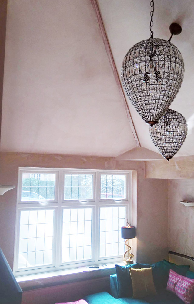 Renovated sitting room with leaded windows and decorative pendant lights