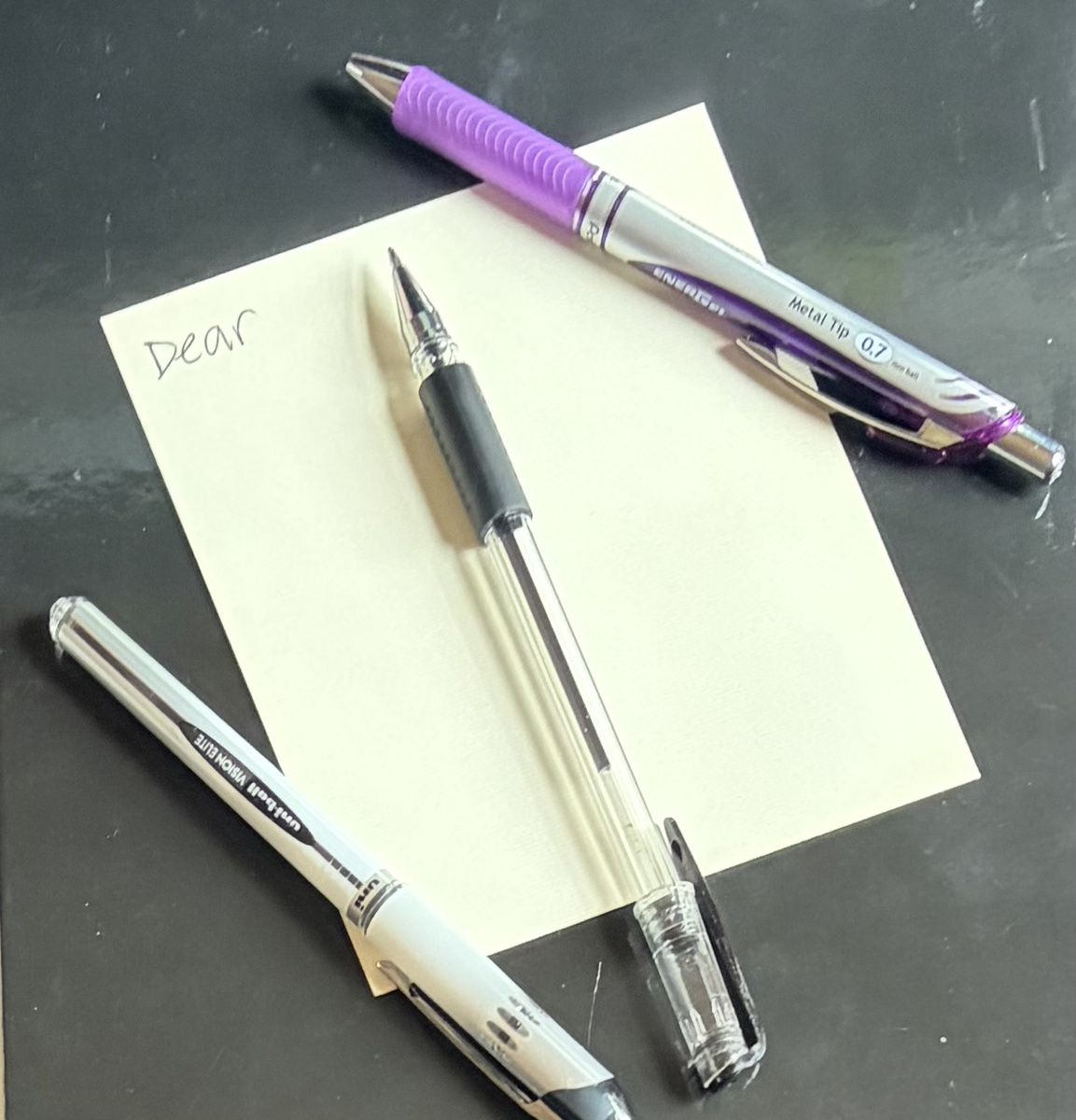 Sheet of writing paper and 3 pens