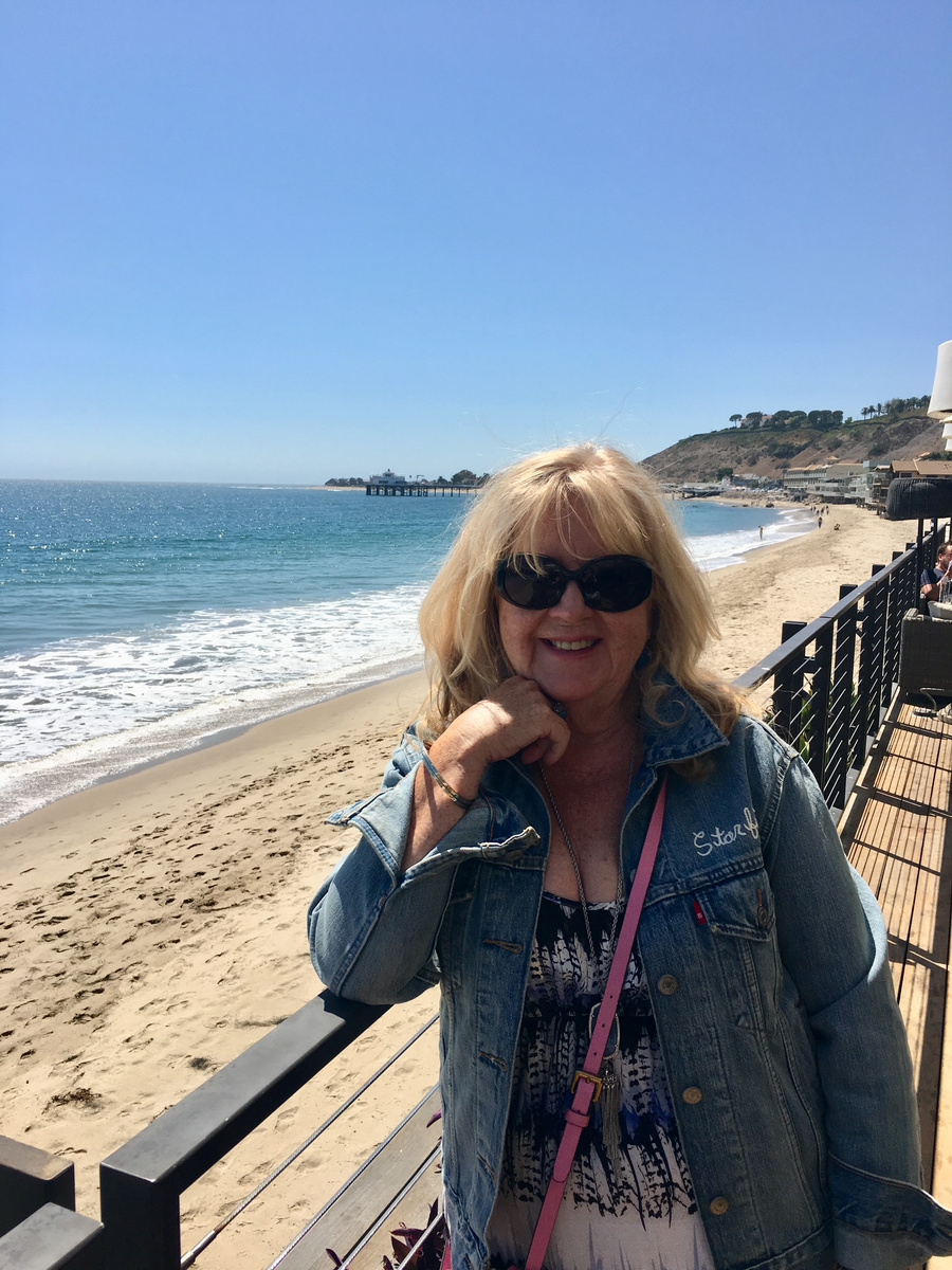 Carole Ryder beside the beach and pier in Malibu