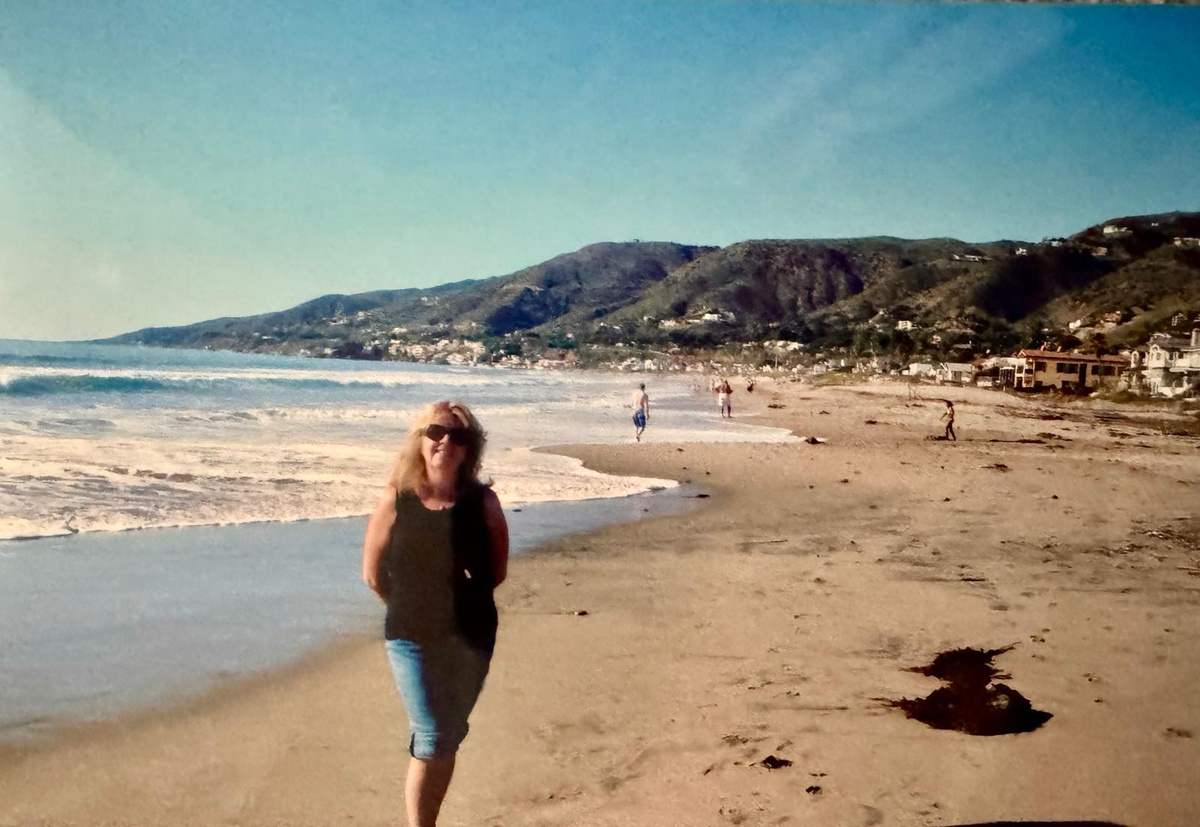 Carole Ryder walking along a beach in Malibu