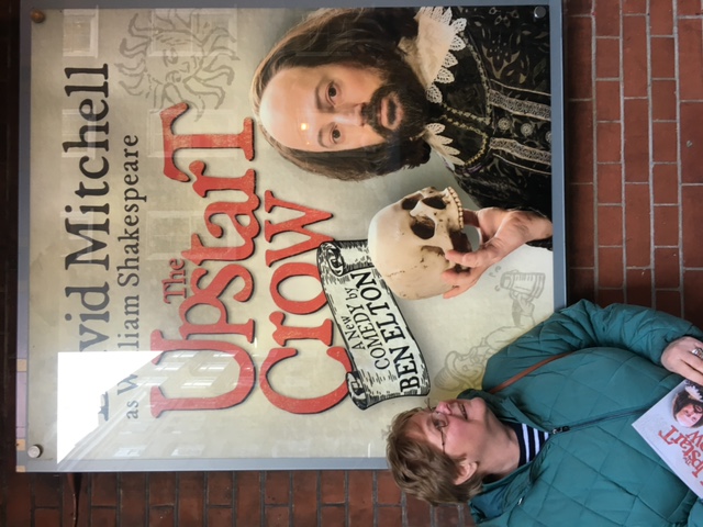 Susan Sachon beside an Upstart Crow poster