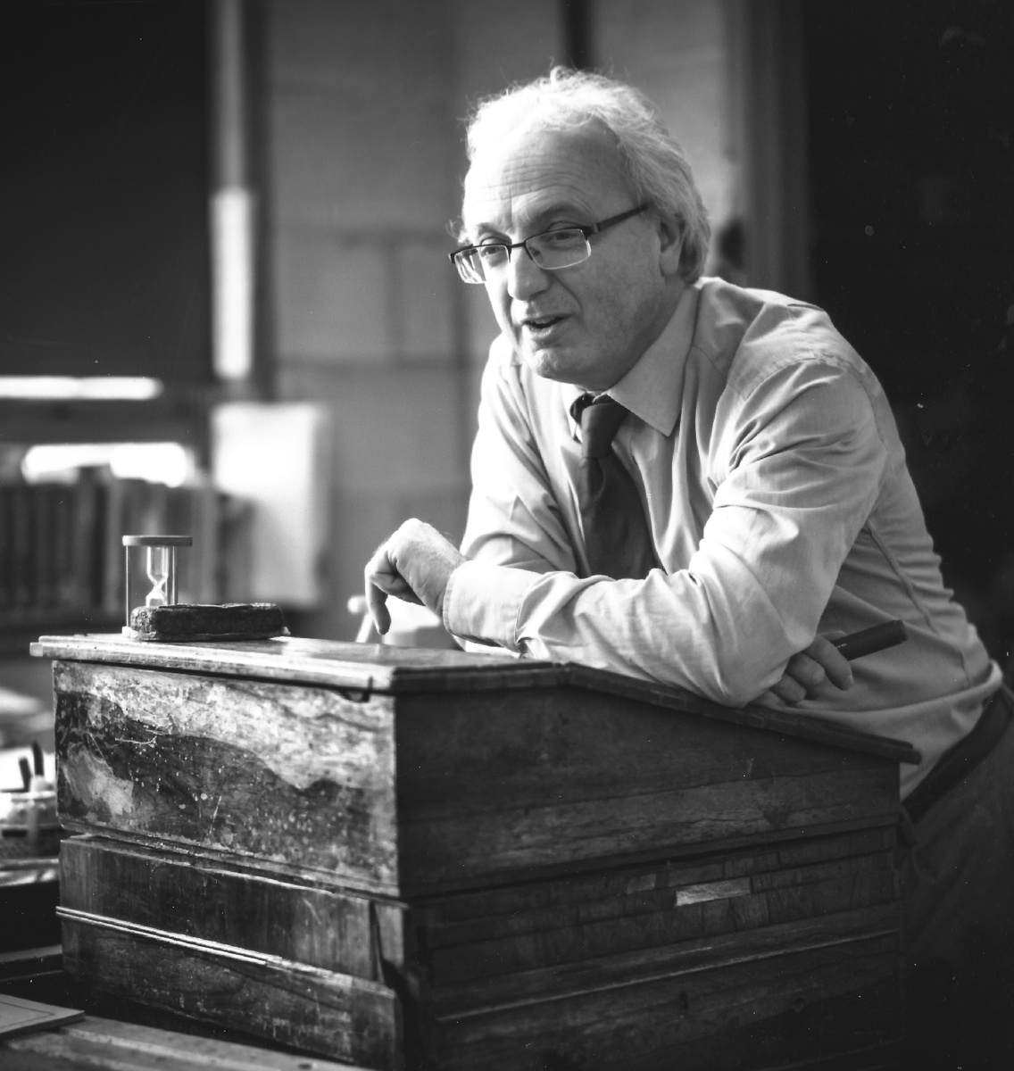 Black-and-white portrait of T D Owen seated at a desk